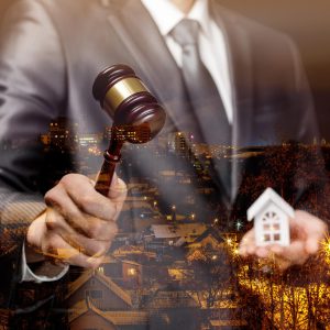 The auctioneer conducts the auction for the sale of real estate on the background of night city.